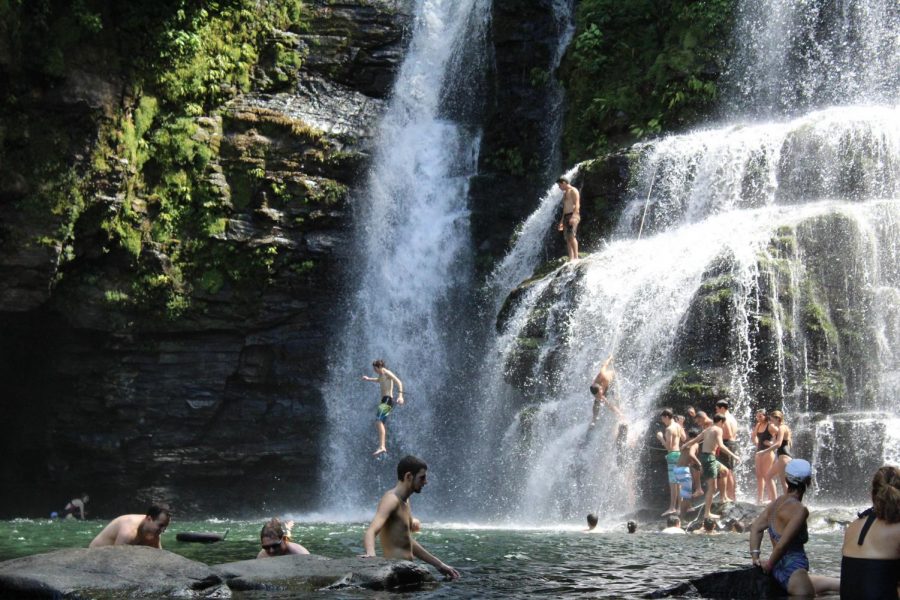 Students from the class of 2019 jump off the waterfall after a day of hiking and horseback riding in Costa Rica. Current sophomores plan to partake in similar adventures next week including ziplining, service activities, and horseback riding. 