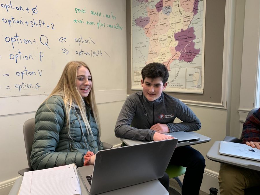 French exchange student Jules His helps freshman Maddie Drda on her French assignment. His is visiting Convent & Stuart Hall for the next two weeks.