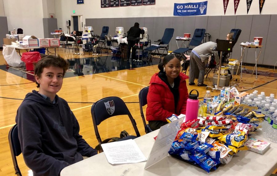 Junior Jade Despanie and Senior Elias Garvey help set up the blood drive. The event was held in the Stuart Hall gym.