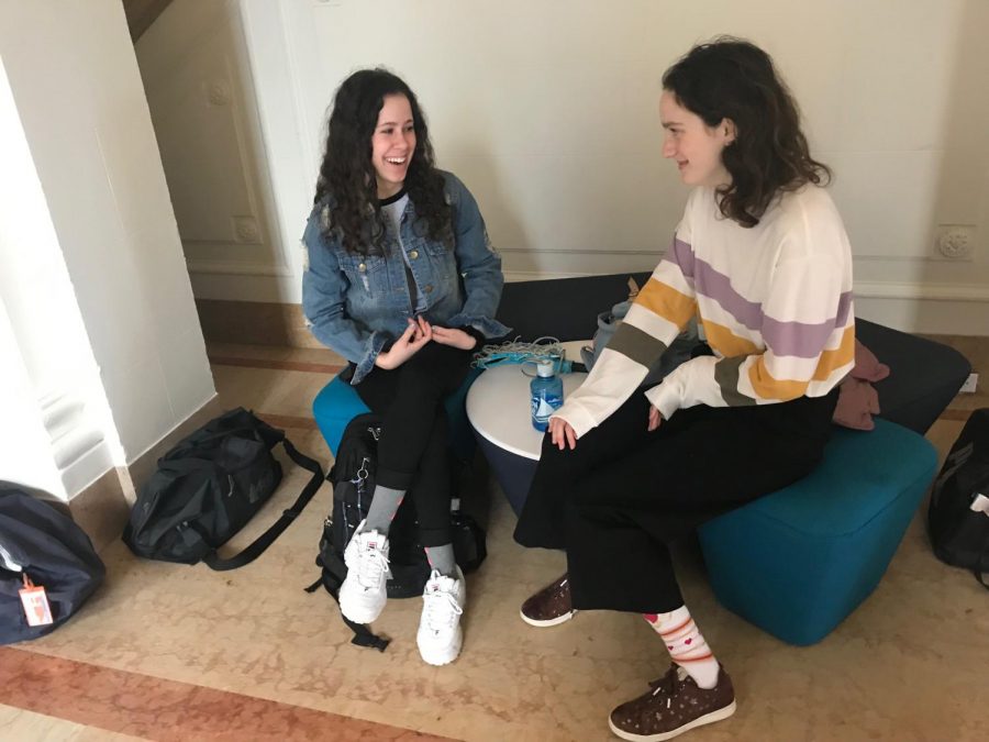 Sophomores Emily LeBlanc, who is visiting from the Academy of the Sacred Heart in New Orleans, and Audrey Scott, her host, talk in the main hall before class. Scott went to New Orleans in February and attended Academy of the Sacred Heart for a week with LeBlanc. 