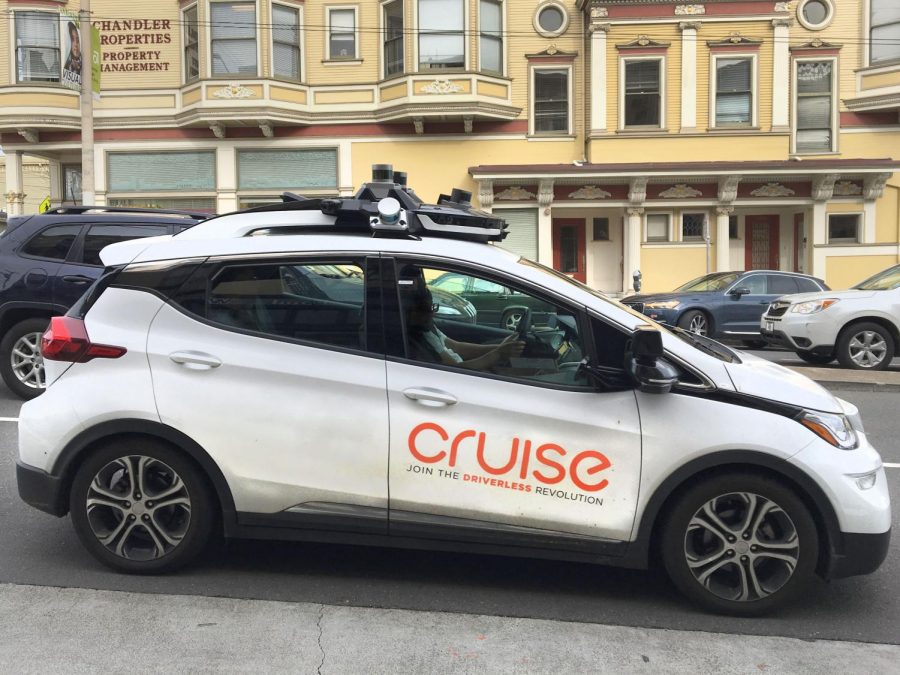 A Cruise electric self-driving vehicle drives down Divisadero Street. The vehicles plan to eventually function as a rideshare service, like Uber or Lyft, for the public. 