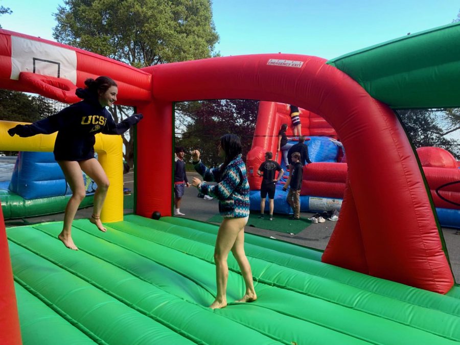Juniors Lila Horwitz and Kai Johnson bounce on one of the bouncy houses at Paradise Beach County Park during Congé. There was also a beach and grass fields for playing sports or relaxing. 
