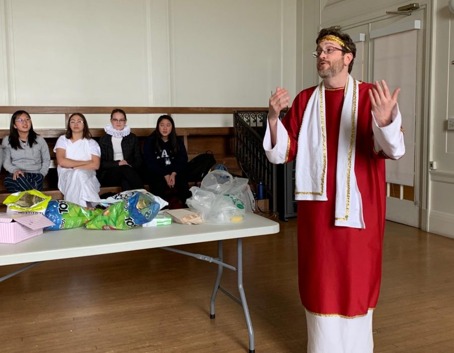 English teacher Mark Botti congratulates the winners of the Shakespearian references contest competition. Botti dressed up as a Roman Senator from the play Julius Caesar. 