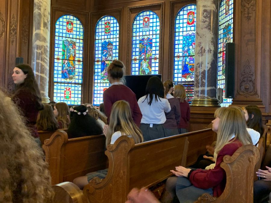 Freshmen walk to the front of the Chapel to receive their flower crowns and certificate of completion of the First Academic from Head of School Rachel Simpson during Prize Day. Some students also received special awards for specific subject areas.