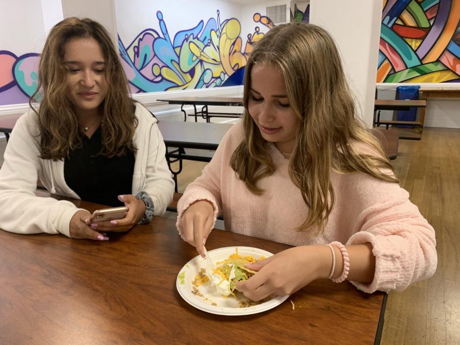 Sophomores Sloane Riley and Mira Chawla eat lunch during the second lunch period at Convent. The modified lunch schedule allows for two lunch periods based on the location of a student’s first afternoon class.
	
	
