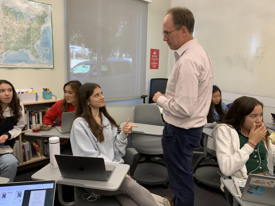 Sophomore Lily Peta asks history teacher Michael. Stafford a question about the early colonists. The class consisted of both discussion and writing time. 