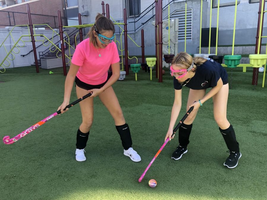 Sophomores Finley Simon and Takohui Asdorian dribble at practice on Syufy Court. Field hockey practices four times a week. 