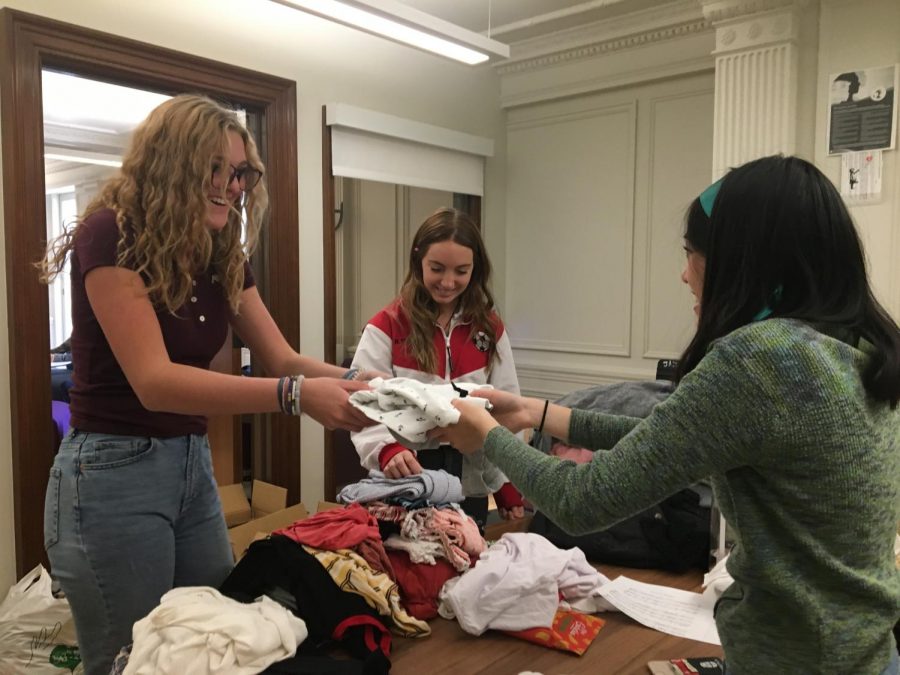 Sophomore Anneli Dolan donates a shirt to the Eco Friends clothing swap. 
Thrifting and purchasing second-hand helps to reduce plastic in landfills and carbon dioxide emissions.
