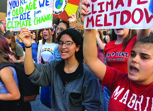 Juniors Jacqueline Guevara and Sofia Jorgenson hold up protest signs and chant during the
San Francisco Youth Global Climate Strike on Oct. 3, 2019. Approximately 31 Convent & Stuart Hall students joined the school strike to march.