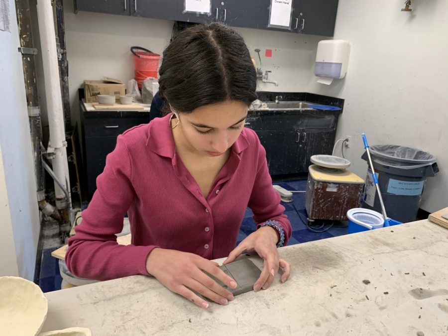 Sophomore Haya Jadallah creates a domino out of clay for her project that represents the domino effect of the contamination of the ocean. This Art Foundation II project pushes students to reflect the environment around them in their work.