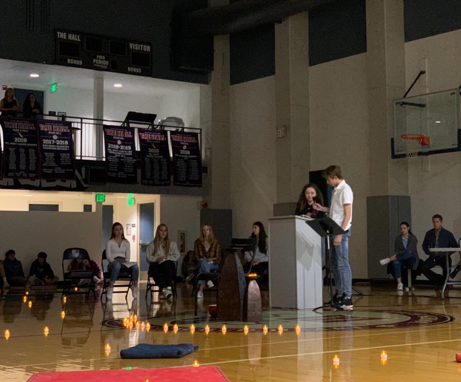 Sophomores Mackenna Moslander and Will Burns speak about their service at the all school chapel held in the gym. The focus was honoring the feast of Sacred Heart sister Philippine Duchesne.