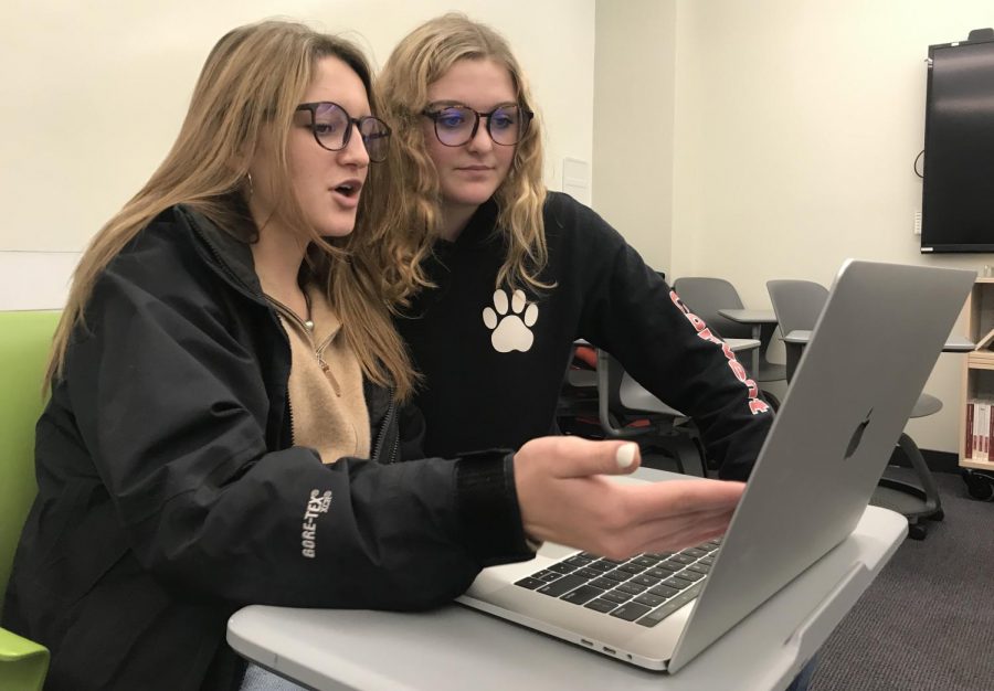 SEEING CLEARLY Sophomores Brit Paulson and Anneli Dolan work on homework while wearing their blue light glasses. Designed to filter out blue light from computers, the lenses look like regular glasses.