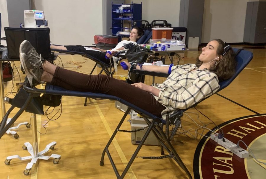 Juniors Kate Baker and Isabel Hoppmann give blood. Donating blood can save up to three lives.