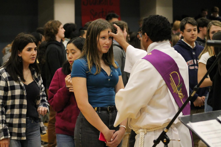 Sophomore Madeleine Richardson receives ashes on her forehead as part of the Ash Wednesday celebration. Ash Wednesday marks the beginning of the forty-day Lenten period during which individuals can fast and reflect on themselves.