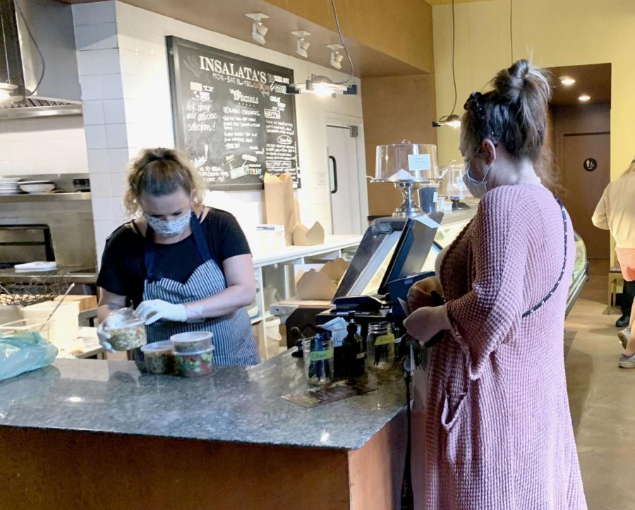 A customer picks up a take out order from Insalatas restaurant in Marin County. Insalatas
recently reopened for takeout service on May 4 to serve daily from 11 a.m. to 6:30 p.m.