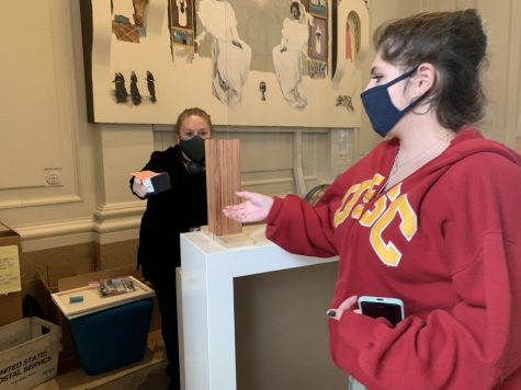 Senior Isabella Wasserman receives her class ring at the front desk of the Broadway Campus. Other seniors opted to have their rings hand-delivered to their homes.