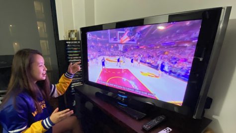 Basketball team captain Audrey Pinard watches the Golden State Warriors play basketball from her home. The Warriors are one of eight teams that was not included in the Disney World Bubble in Florida.