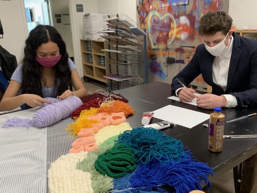 Seniors Alliza Manayan and Wolfgang Tobaison work on large-scale art pieces in preparation for the art show opening March 11. Seniors have worked on their exhibition as a part of the IB Visual Arts course. 
