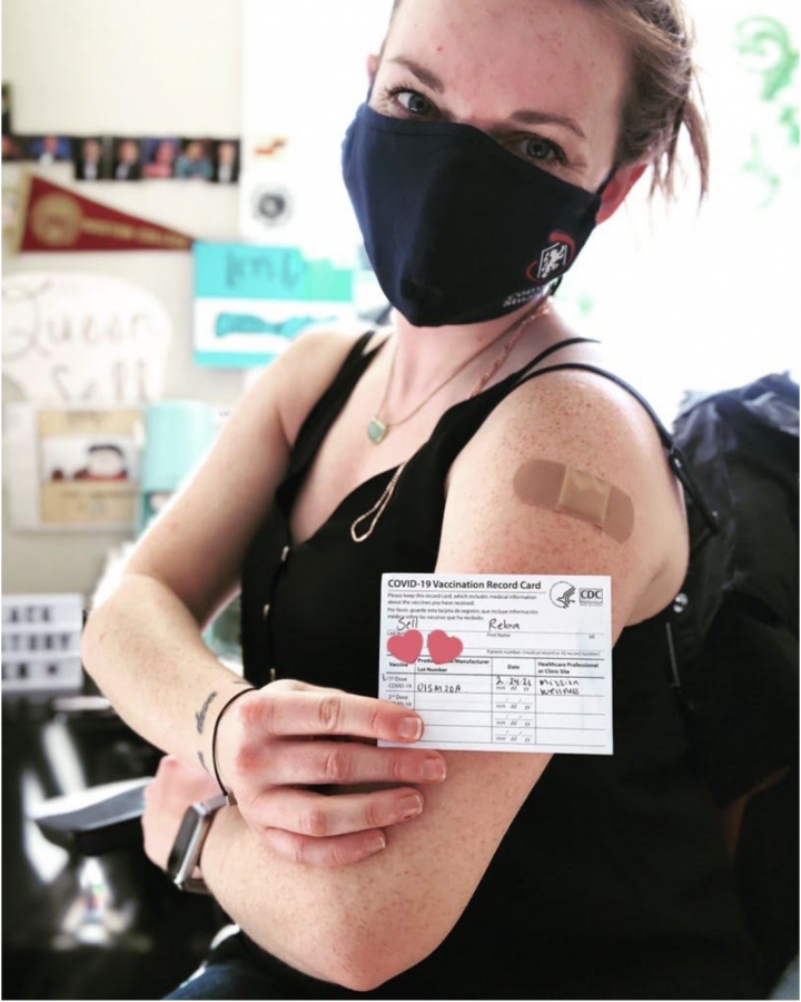 Librarian Reba Sell shows off her vaccination record card. California has moved into vaccinating individuals in Category 1B, which includes childcare workers and adults working in K-12 institutions. 