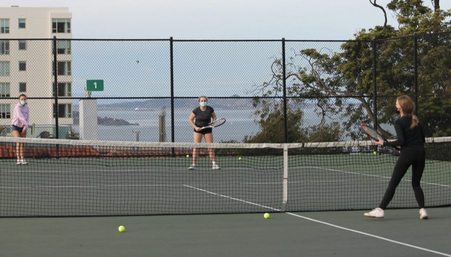 Juniors Amelia Abernethy, Sloane Riley and Paige Retajczyk practice in their cohort at the Alice Marble Tennis Courts at George Sterling Park on Feb. 12. Season 1 sports, including cross-country, golf and tennis, began on Feb. 8.