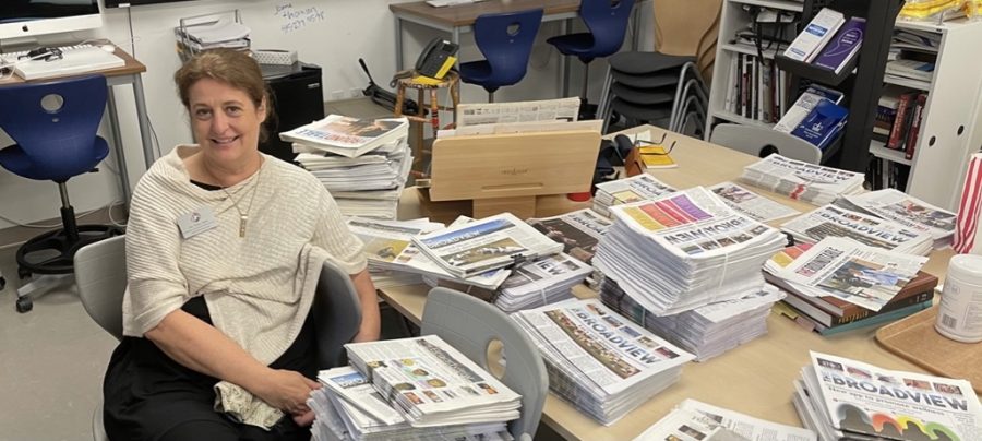 Scholastic Journalism & Media Director Tracy Sena sits by stacks of The Broadview as she cleans out the Publications Lab before retiring. Sena has advised The Broadview for more than two decades and has overseen newspapers for both high school divisions, Convent Elementary and the yearbooks. 