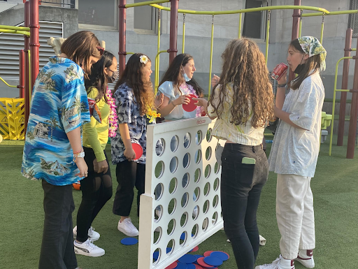 A group of freshmen gather on Syufy Court to play connect-four during the Carnival. The theme was tropical glow and the event ran from 6-8p.m.