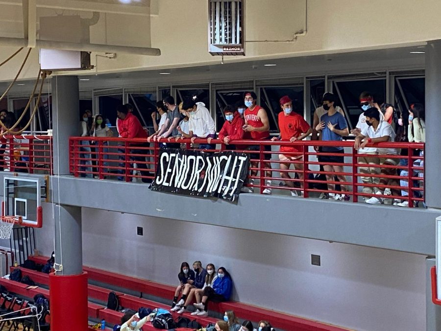Student+fans+support+the+varsity+volleyball+players+and+watch+from+behind+the+student-made+banner.+Many+family+and+faculty+members+came+to+watch+the+game+to+support+the+seniors.+%0A