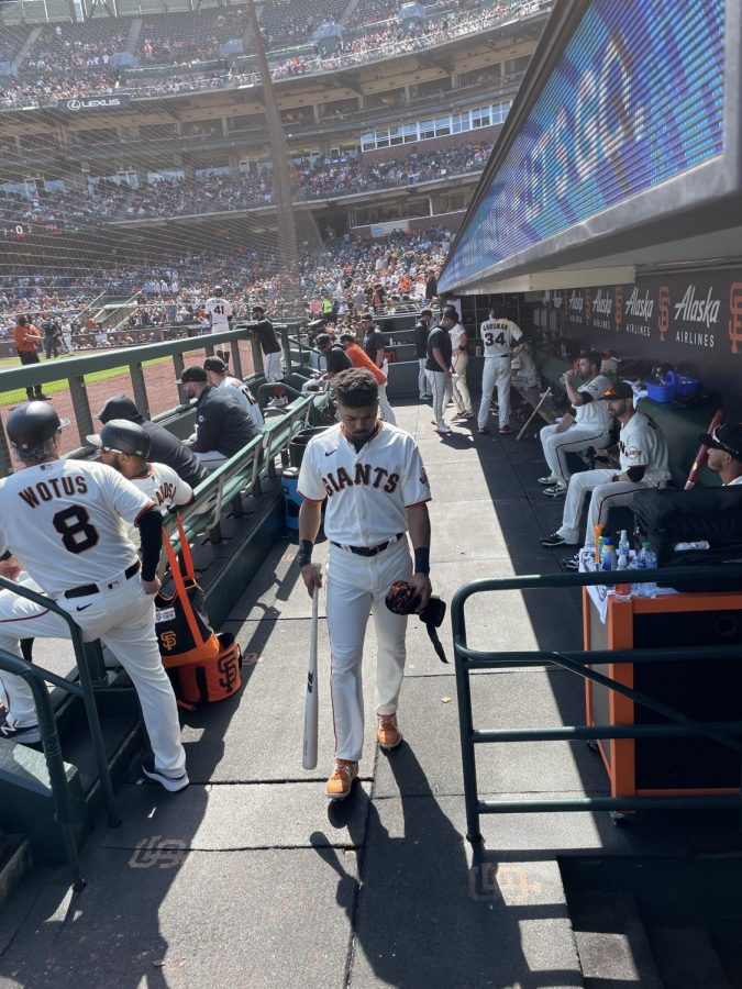 Outfield LaMonte Wade Jr. returns to the clubhouse from the dugout. The Giants have already clinched a sport in the 2021 postseason. 