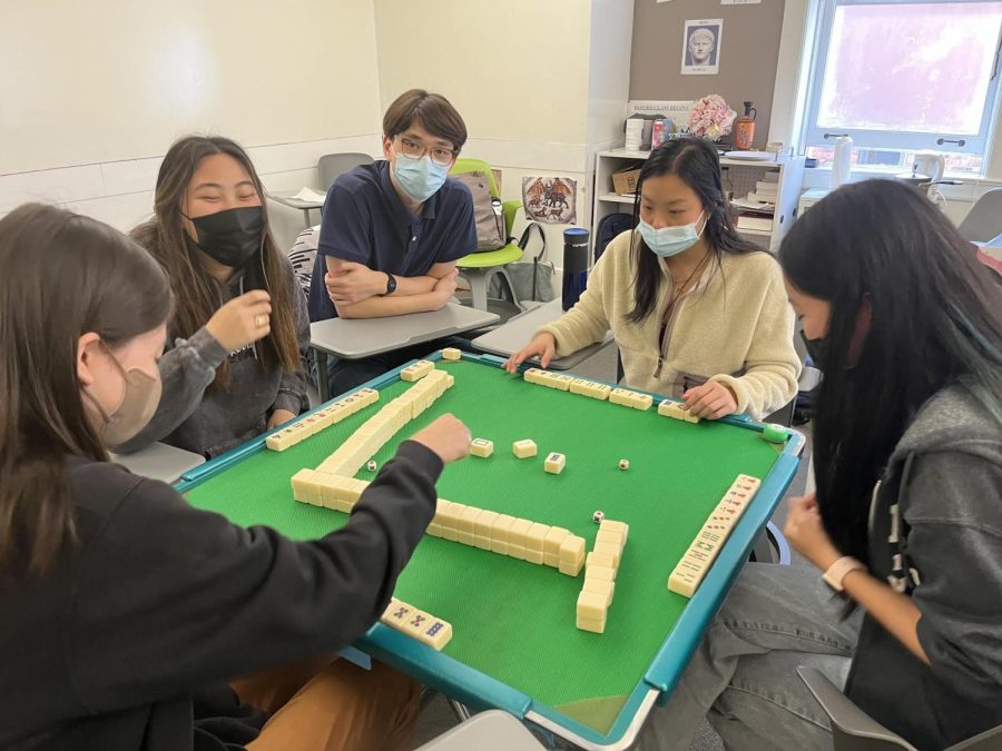 The Mandarin IB SL and HL classes come together to play Mahjong. The game allows for up to four players at once, each having a deck of tiles with the purpose of making four combos and one pair to win.