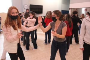 Freshmen Peyton Spaht and Madelon Podell practice a skill they learned to get out of a wrist hold. Both ninth and tenth graders had the opportunity to take part in the self defense classes during community time this week. 