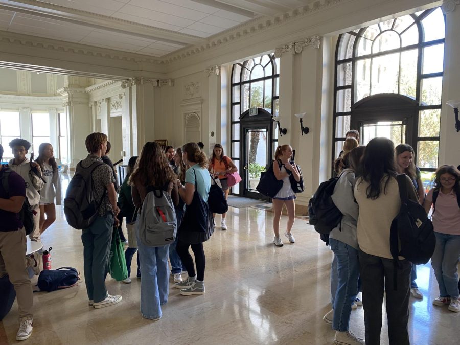 Students mingle in the Main Hall after school Wednesday. Most students, to comply with the dress code standards, wear blue jeans or khakis and a collared shirt to school.