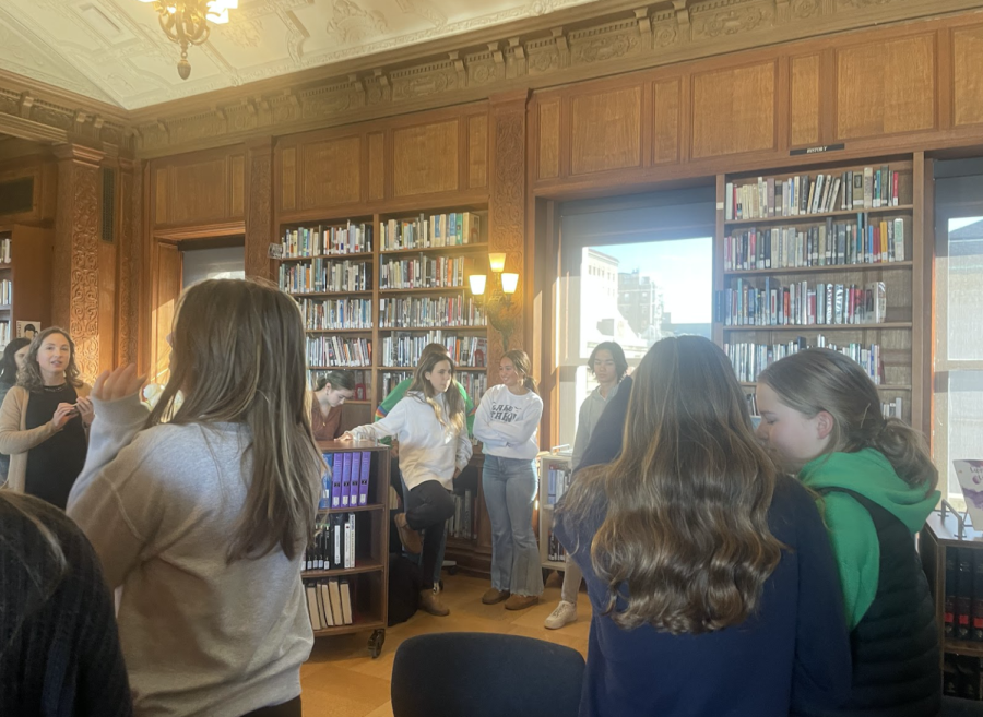 French department preparing to sing ‘Il est ne le divin enfant’ in the Williams library. Noels has been a tradition at the Schools of the Sacred Heart for 135 years. 
