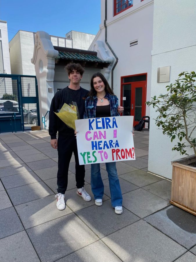 Senior Andrew Williams asks Senior Keira Blattberg to prom with a poster and flowers. To win the free tickets to prom, students are required to send in a photo and video of their promposal and receive the most likes from the student body.