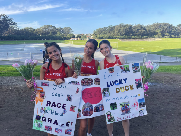 Grace Gallagher, Karina Abernathy, and Deirdre Kenny are three of the five seniors on the cross country team. Holding the posters given to them by their teammates, as they celebrate their senior night together. 