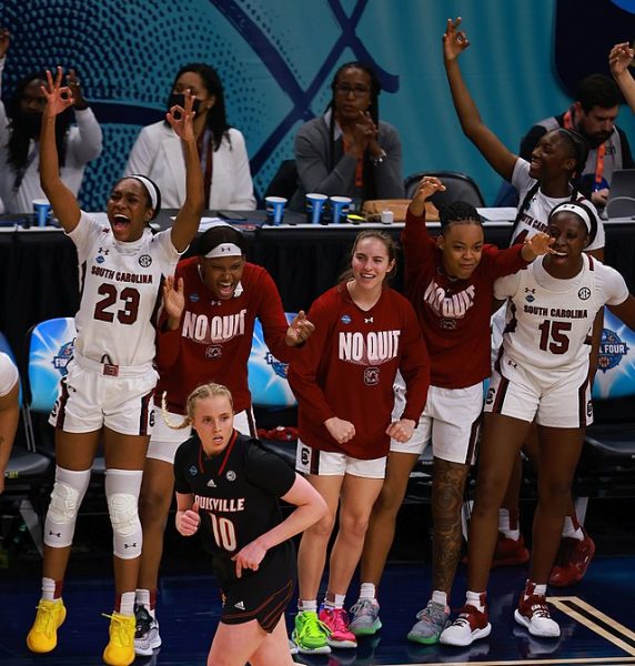 The players of University of South Carolina’s 2022 team celebrate a basket. The team has been undefeated this season so far under Dawn Staley, who has been the team’s coach since 2008.