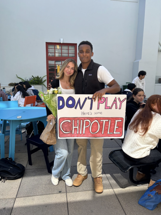 Junior Annania Sirak prom-poses to junior Thea Pratt with flowers, a sign, and Chipotle. This photo is also part of the school’s account for all of the prom-posal pictures.
