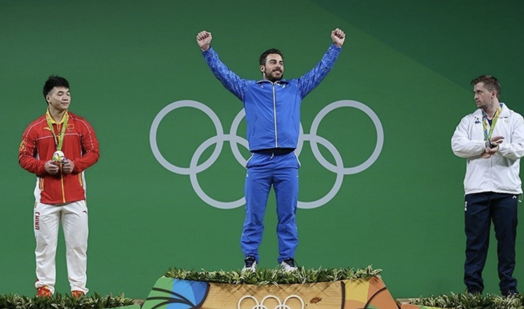 Olympians on the awards podium. The rings symbolise the union of the five continents, the participation of the athletes at these Games and express the activity of the Olympic movement.