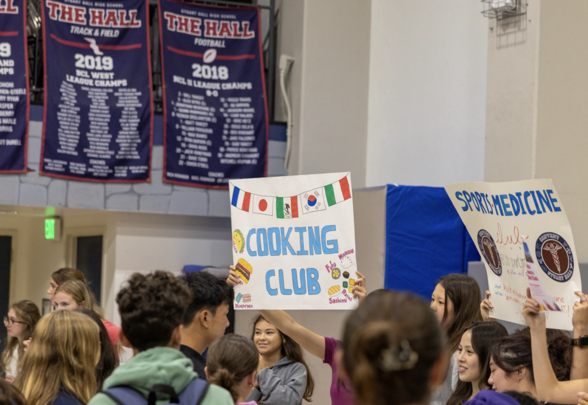 Club leaders show off their posters at the annual Club Fair. Other booths also incorporated signup sheets and snacks to encourage students to join their club.
