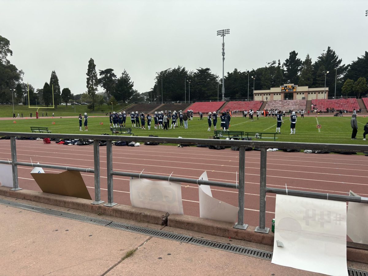 The Stuart Hall football team plays at Kezar Saturday afternoon. Signs students made to cheer on players and show support for their school can be seen on the sidelines.