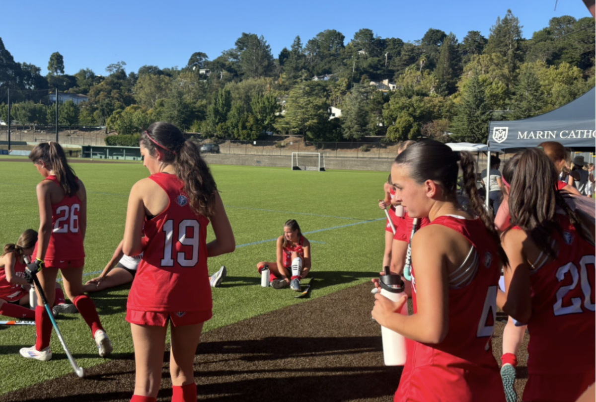 The varsity Convent field hockey team post-game forming a stretch circle to end their game. This game kicked off their 2024 season going head to head with Marin Catholic. 
