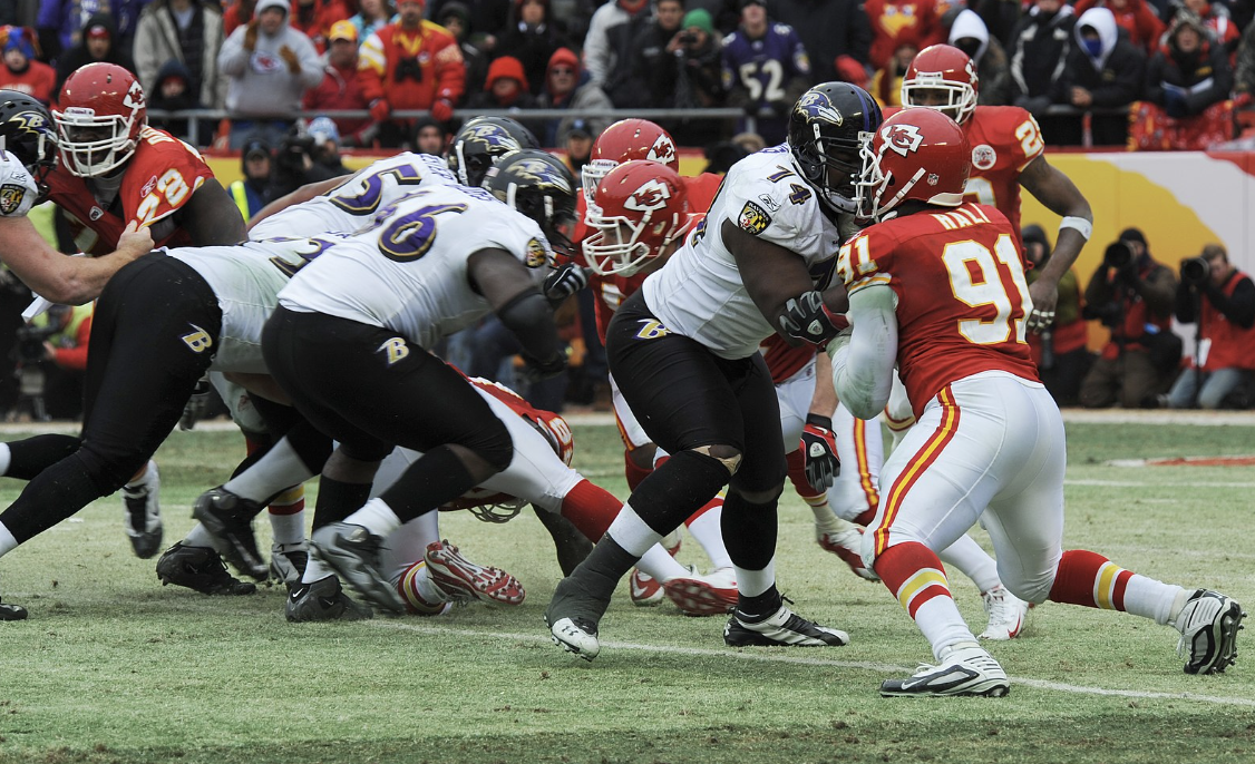  Kansas city chiefs and Baltimore Ravens going head to head during the 2010 playoffs. Offensive tackle by Ravens’ Micheal Oher blocks Chiefs’ linebacker Tamba Hali. 
