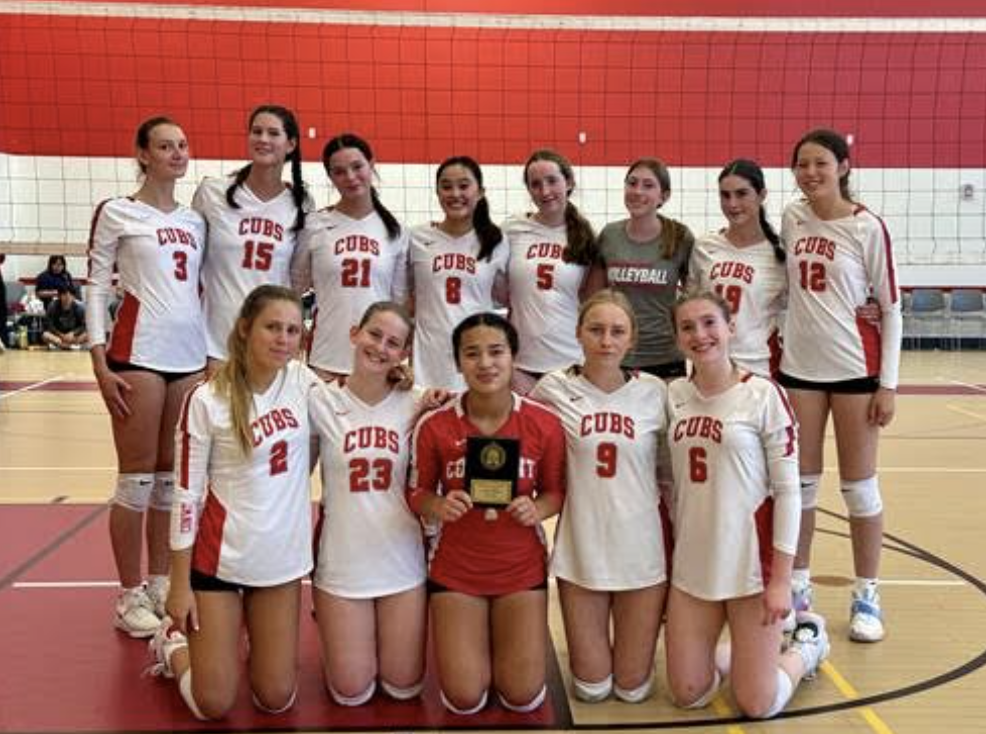 The Varsity Cubs team poses with their trophy. 
