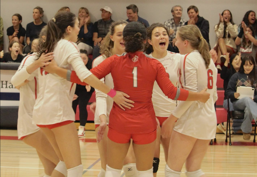 Varsity volleyball players celebrating during a game against Lick-Wilmerding. This took place during the 2023 volleyball season. 
