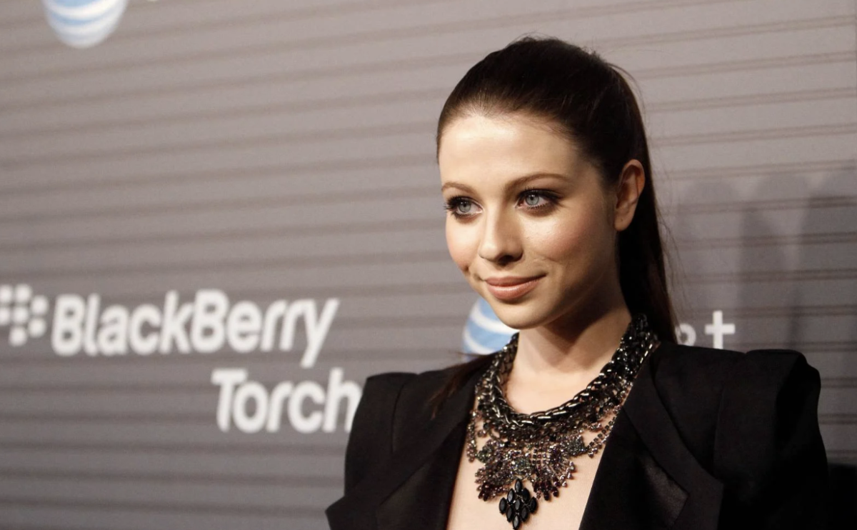  Michelle Trachtenberg posing on the red carpet. She rose to fame early, appearing across productions including Buffy the Vampire Slayer, EuroTrip, Gossip Girl, and more. 
