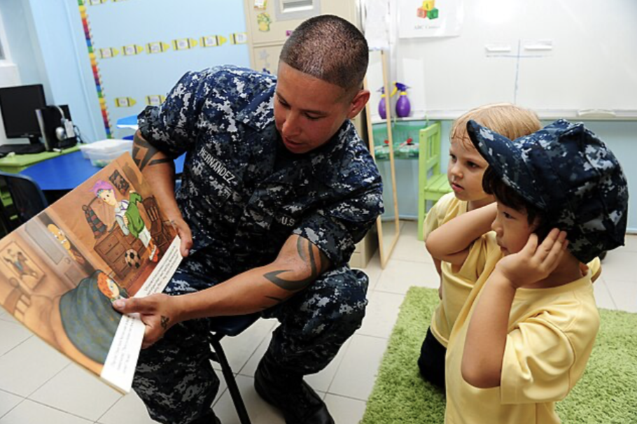 Official US navy reads to children at the International Community School Singapore. This was during a service project with sailors from the Arleigh Burke-class guided-missile destroyer USS Pinckney.