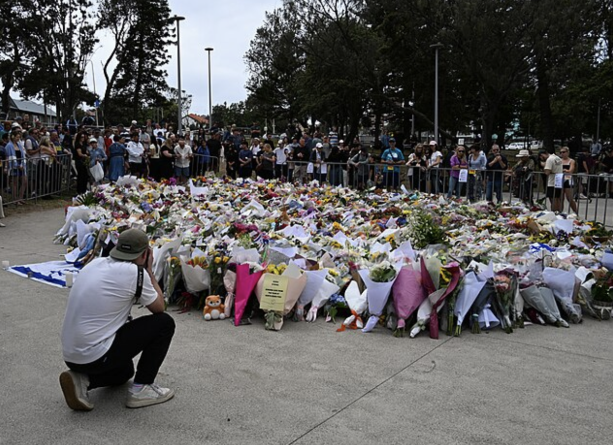  In the aftermath of the massacre, community members have created a burial site at the beach to pay their respects. The flowers are for the people who died or were hurt in the incident.    