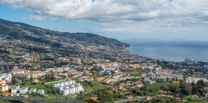 The beautiful city of Madeira, Portugal lays just above the ocean. The island is filled with huge volcanic cliffs and volcanic sea pools which visitors love to swim in.