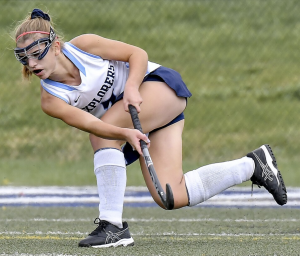 A field hockey player makes a great run to intercept a pass. She’s in a position to make a quick turnaround for her team.