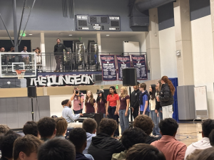 Sophomores and juniors sing along to Dr. Harris’ piano accompaniment to “Love Theory”, while students and faculty enjoy the music. The performance took place in the Dungeon at the PO campus before a designated club meeting time.